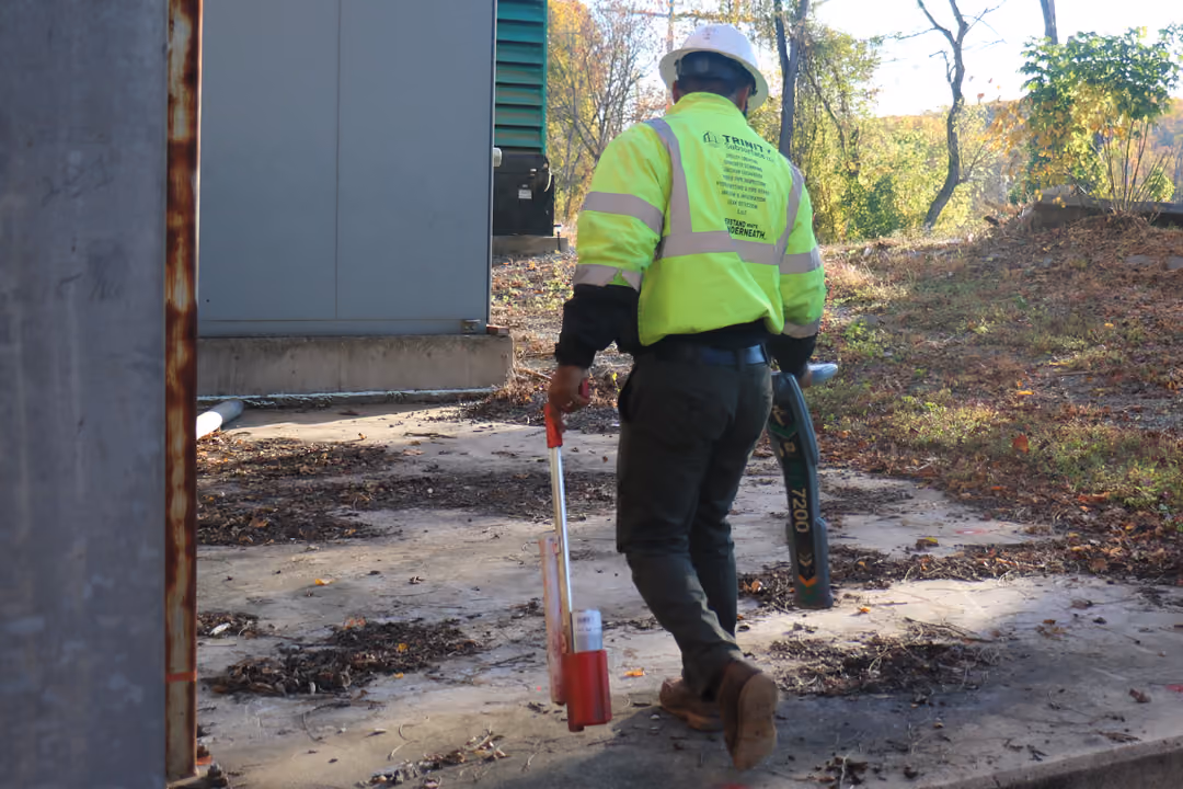 An image of a utility locator using EM technology to scan concrete.
