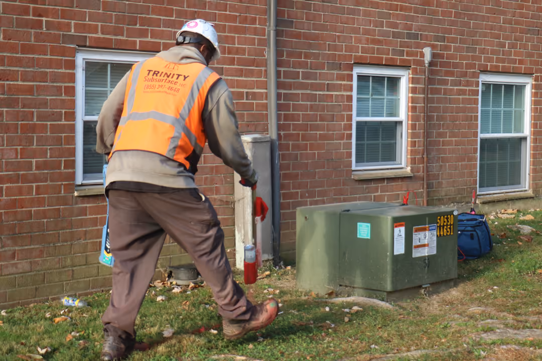 An image of a Trinity Subsurface utility locator scanning around an apartment complex.