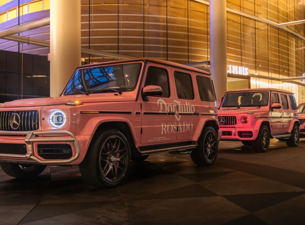 A fleet of five stadium & arena shuttles with custom LSU Tigers coach bus wraps lined up outside Tiger Stadium. This multi-vehicle brand takeover for event shuttles demonstrates large-scale logistics for sports marketing, ideal for VP of Marketing and Agency Account Directors planning high-capacity game day activations.