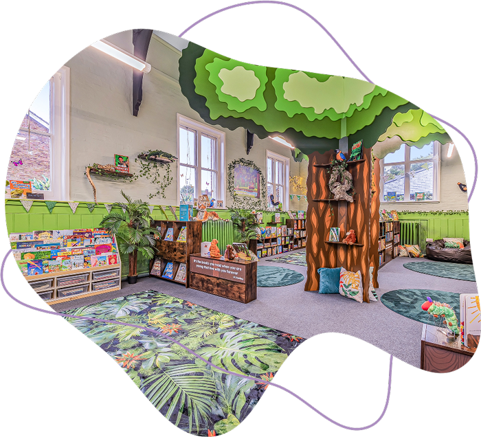 Bright and colorful children's library area with tree-shaped bookshelves, leafy decor, round rugs, and shelves filled with books.