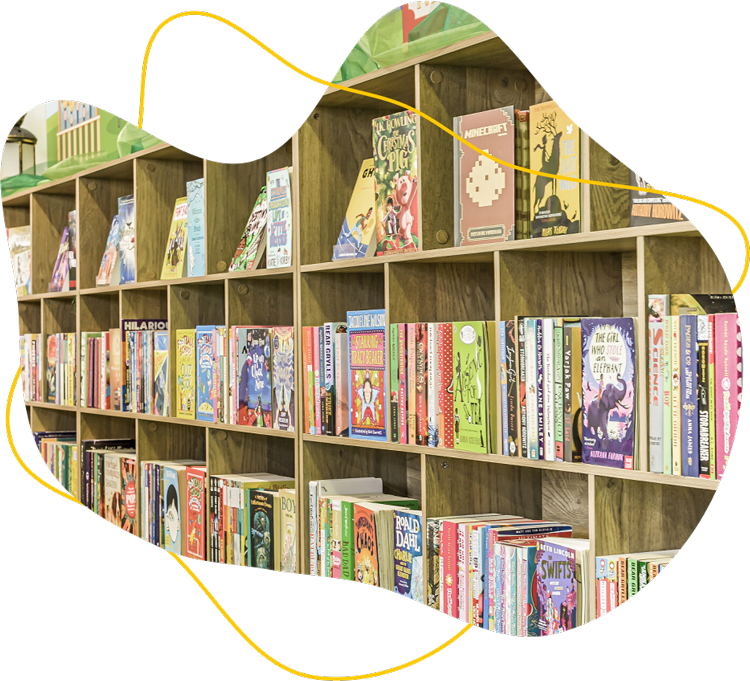 Wooden bookshelf filled with colorful children's books neatly arranged both spine-out and facing forward.