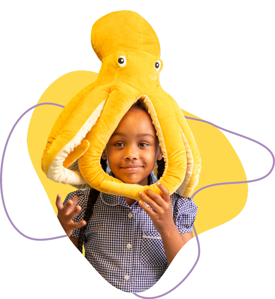 Smiling child wearing a large yellow octopus plush hat with tentacles around the face.
