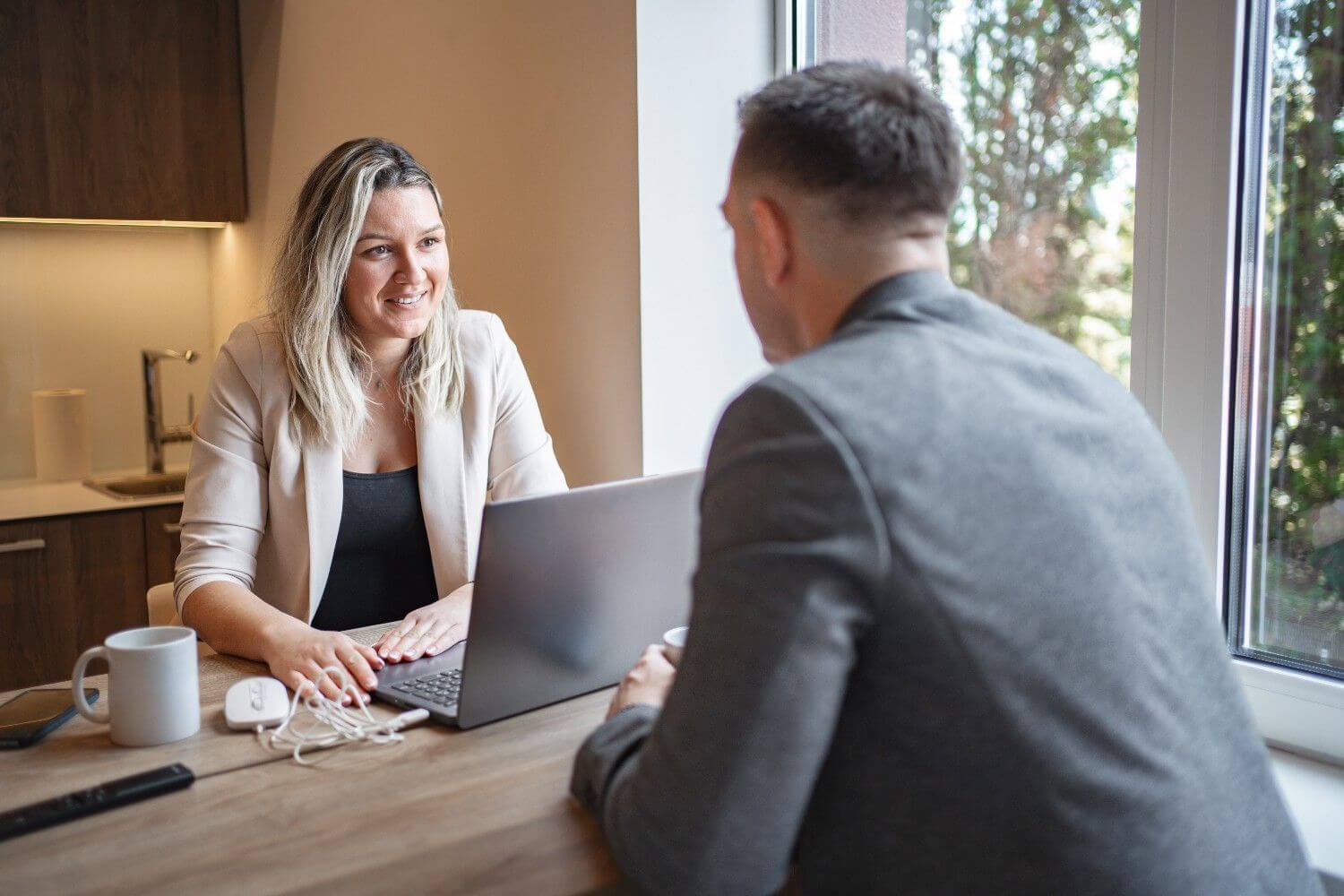 Owner and client working on laptop at table