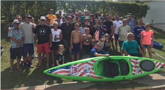 The Team infront of a Kayak