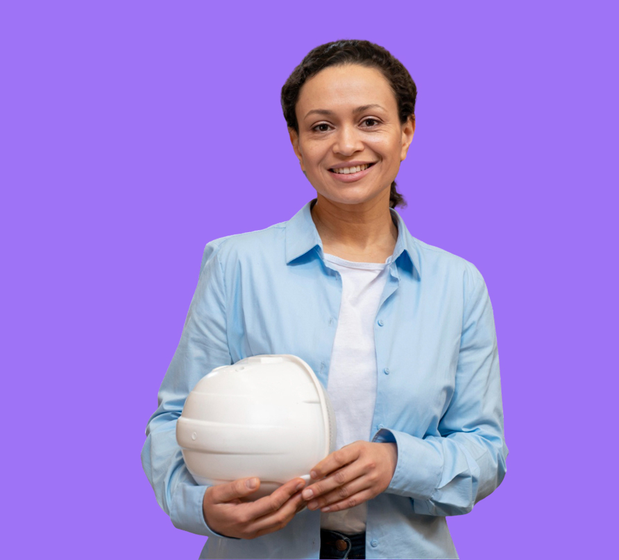 Smiling woman in a light blue shirt holding a white construction helmet against an orange background.