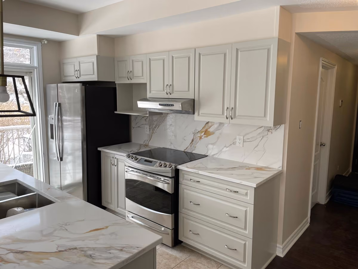 Kitchen cabinets have been painted white in an Ottawa home kitchen.
