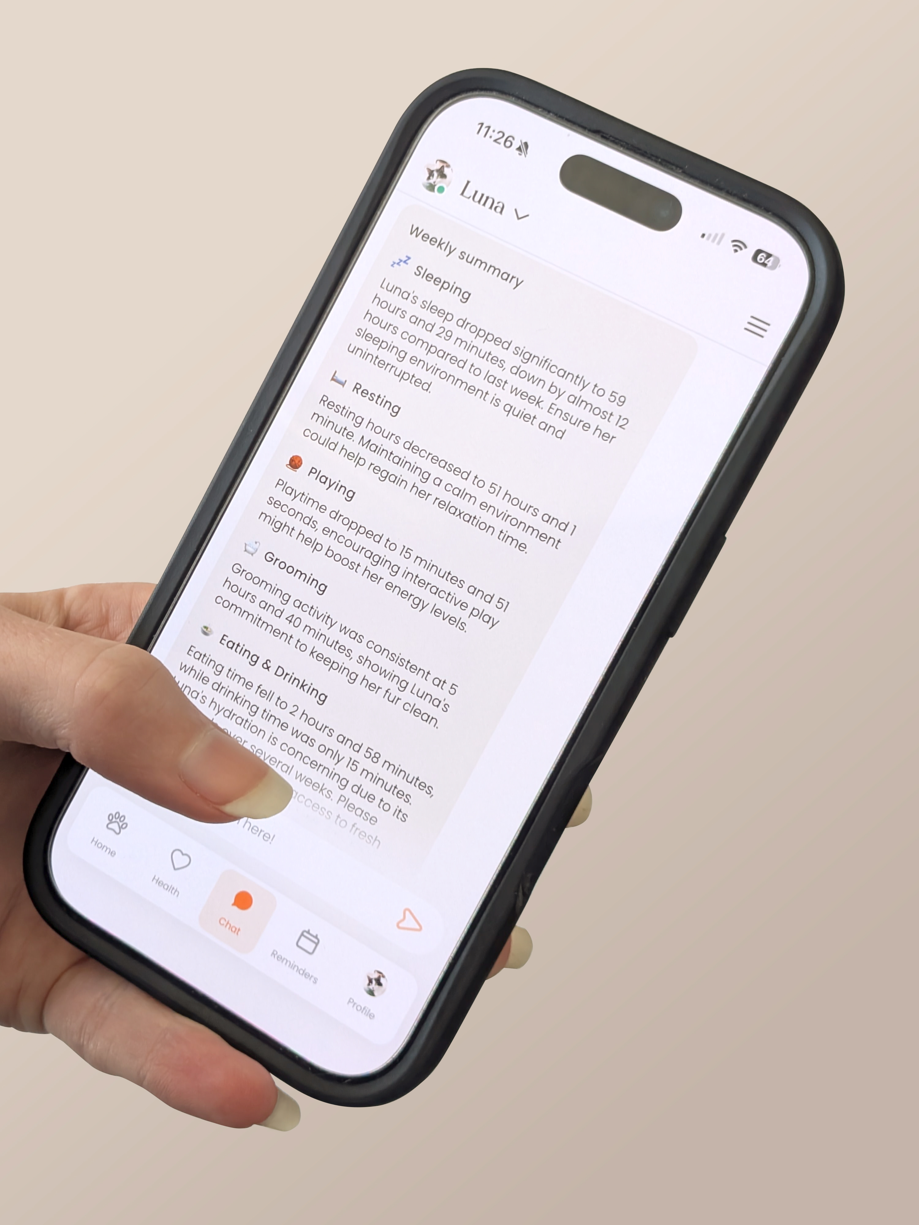 A hand holding a phone with the screen showing a chat feature of Moggie that shares a weekly report of how the cat is doing.