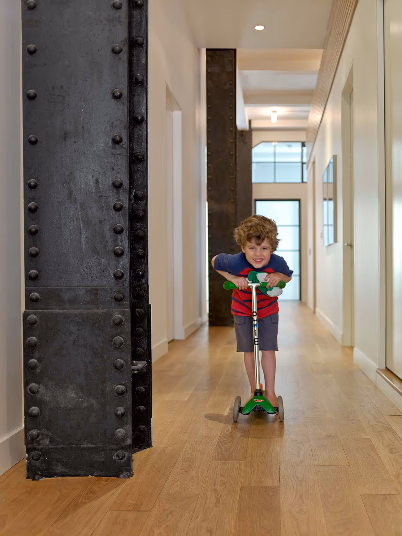 Flat Iron Loft Child on Scooter in Hallway