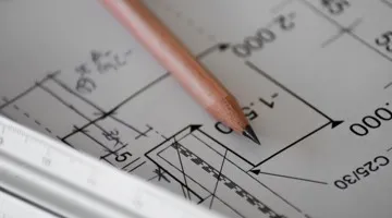 blueprint plans with pencil laying on them