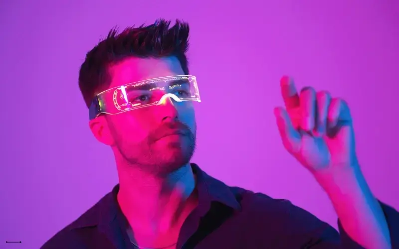A man is wearing futuristic AR glasses and using them to interact with something