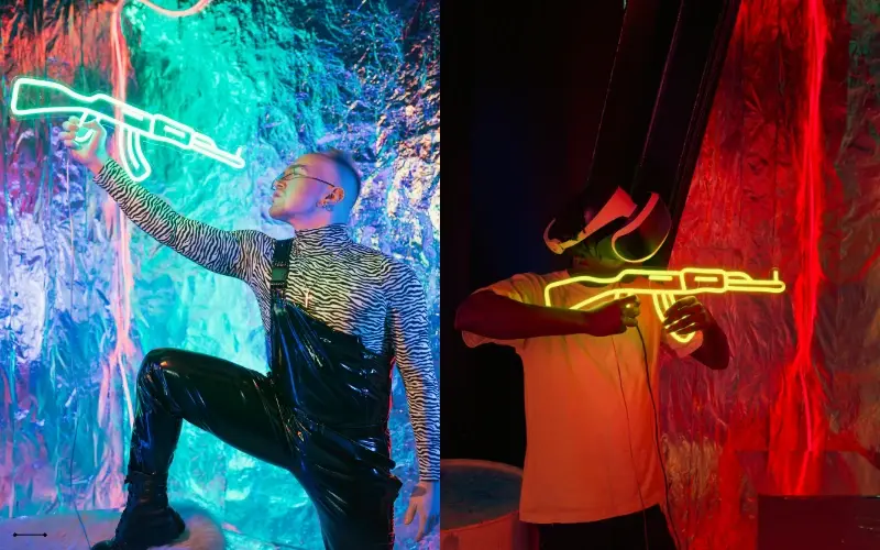 Group of people wearing VR headsets and holding haptic gun controllers inside an immersive gaming arena