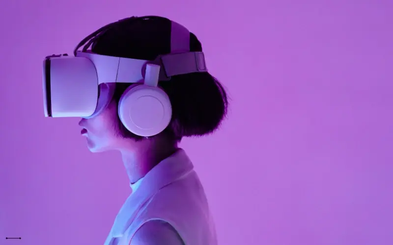 Young woman wearing a VR headset, fully immersed in a virtual environment
