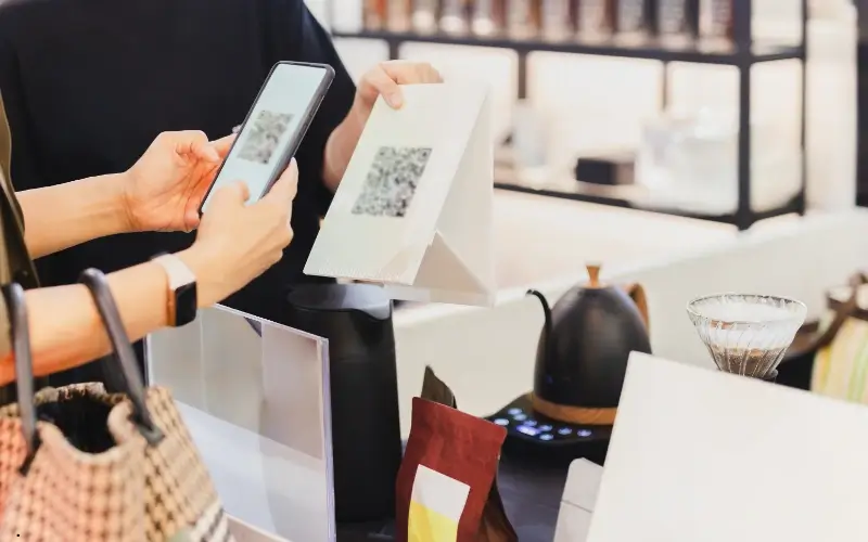 A person scanning a QR code with a smartphone to join or play an e-game, symbolizing interactive participation in virtual gamification.