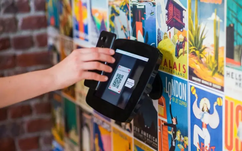Attendee scanning a QR code at a digital check-in station during a college career fair.