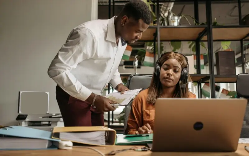 Help desk staff assisting students at a college career fair.
