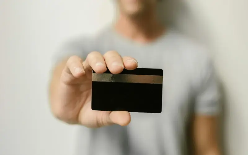 Person holding a card, symbolizing secure handling of student data and privacy at a college career fair.