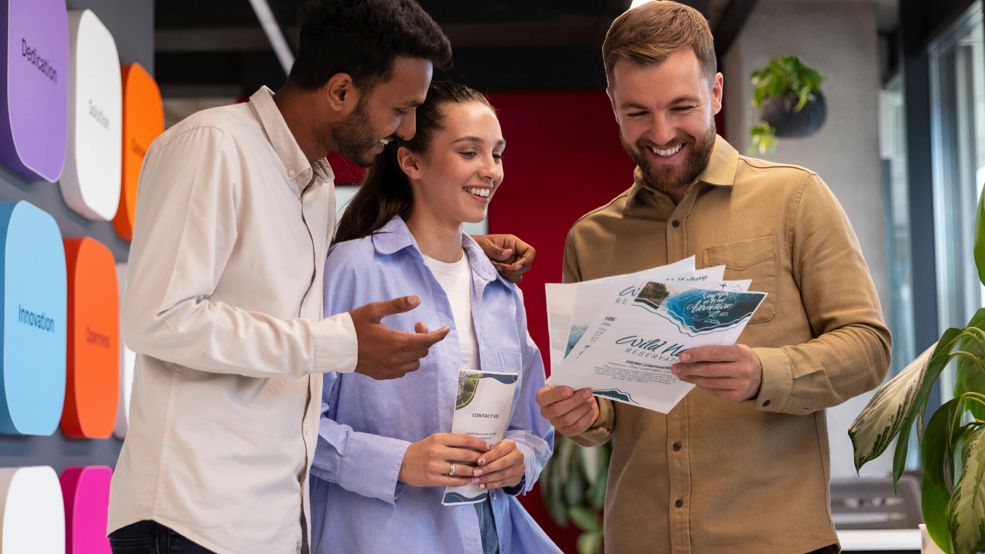 Team of event organizers reviewing brochures and creative materials, showcasing real-world event marketing examples in action.