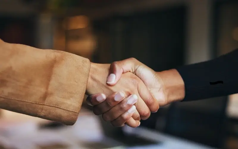 Handshake symbolizing aligned value in modern event sponsorship package tiers.