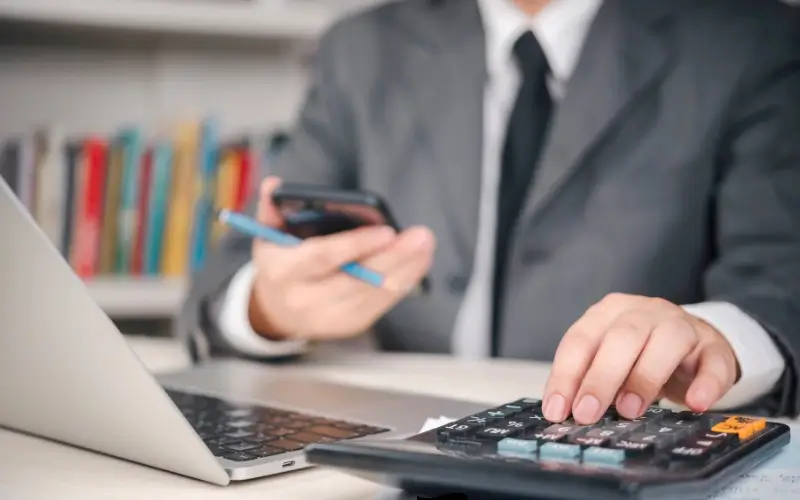 Person calculating sponsorship asset value for modern event packages.