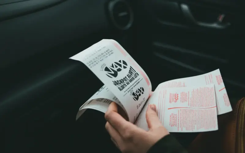 Close-up of someone reviewing event tickets, representing time-based pricing and buyer behavior.