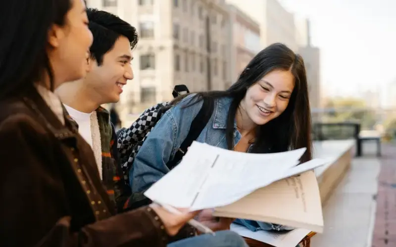 Students reviewing resumes and career materials together, representing a career fair organized by academic majors and career pathways
