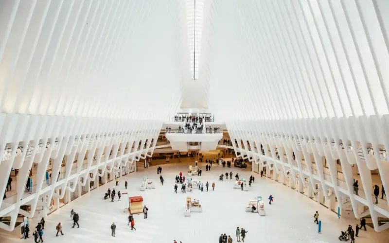 Large exhibition hall with open walkways and attendees moving between exhibitor spaces.