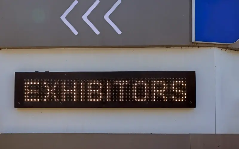 Exhibitors sign highlighting the importance of securing exhibitors early in event planning.
