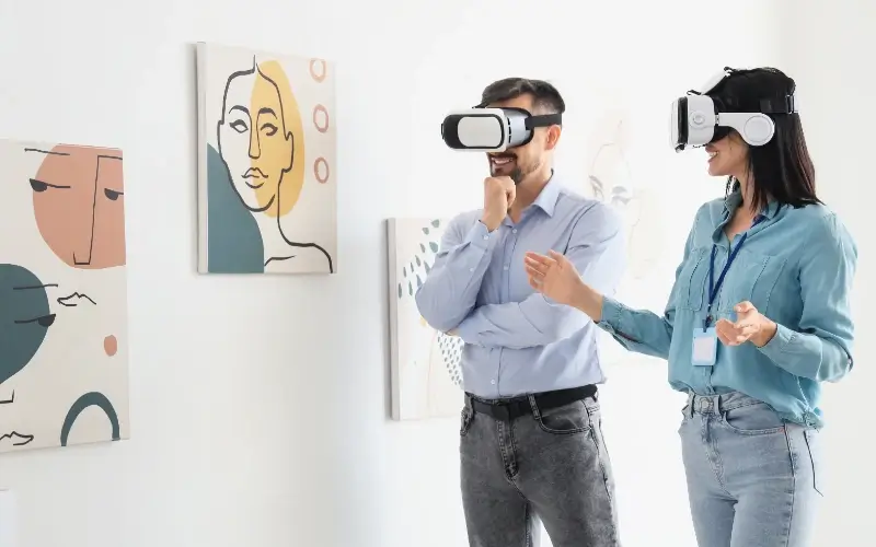 Two attendees interacting with digital artwork inside a VR-powered virtual exhibition.