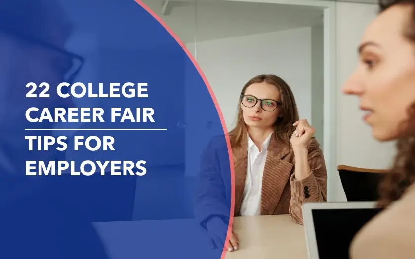 Two smiling recruiters in business attire sitting at a table with resumes and pens, engaged in a friendly conversation with a candidate during a career fair interview.