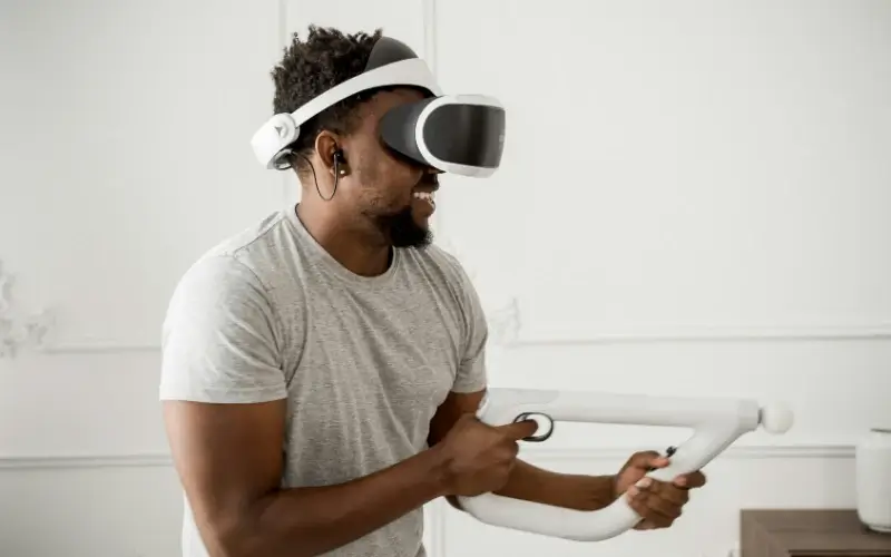 Attendee using a VR hardware headset with handheld controller, illustrating immersive XR experiences in live event environments.