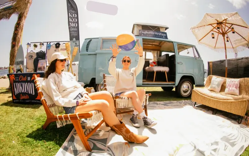 Kokomo Spirits branded pop-up lounge activation with retro van creating immersive event sponsorship experience.