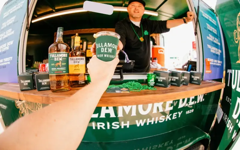 Tullamore D.E.W. branded pop-up bar activation serving drinks at event sponsorship booth.