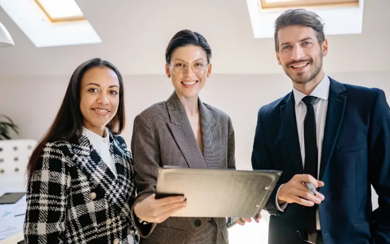 Recruiters reviewing candidate information on a tablet while planning interactions during a virtual career fair.