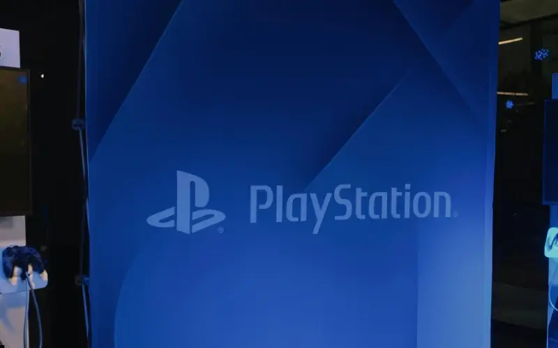  Gemini said A PlayStation branded backdrop stands as a prominent physical asset that anchors a dedicated sponsor zone within an event space.