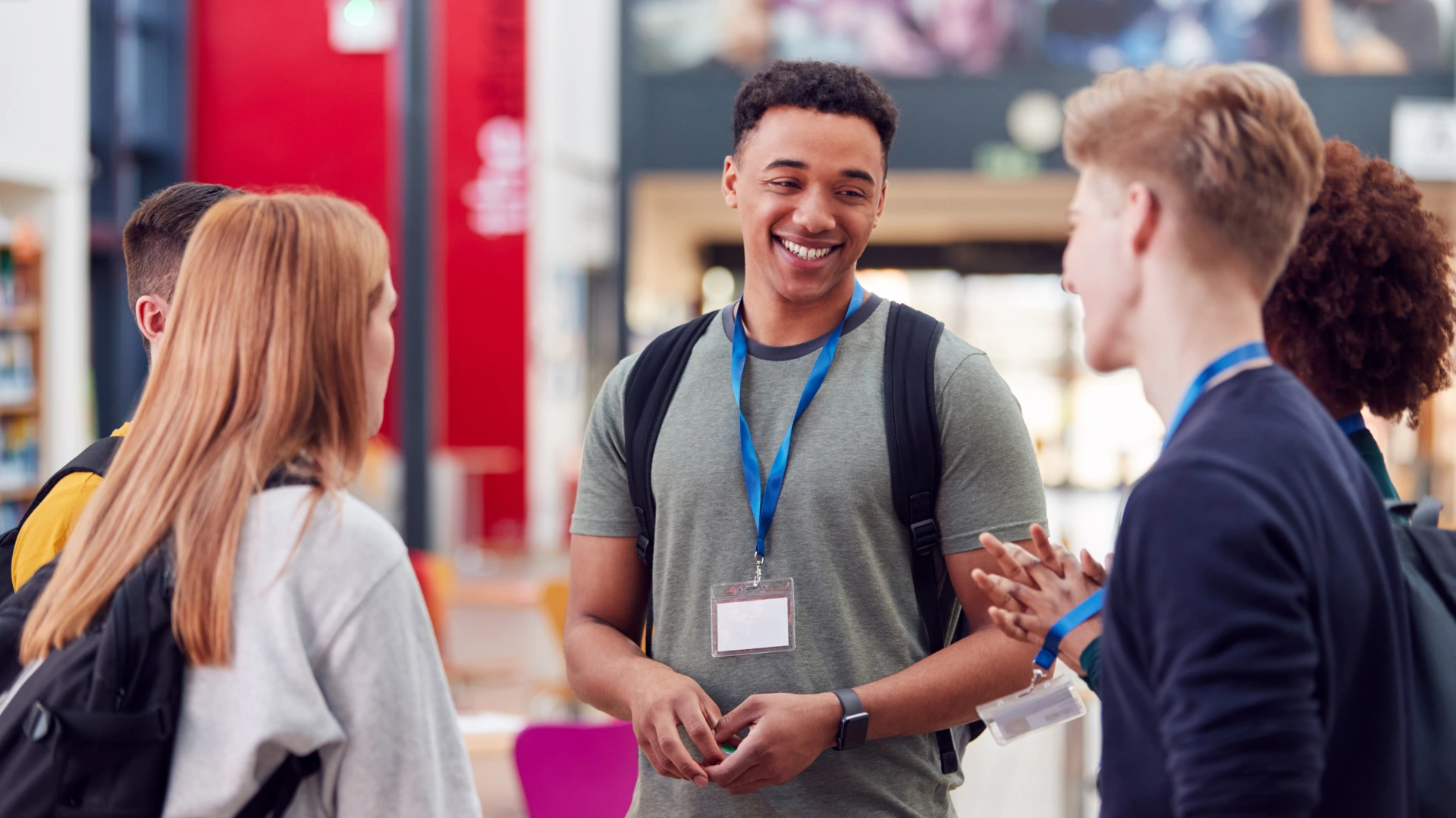 Students networking and talking at a college career fair event.