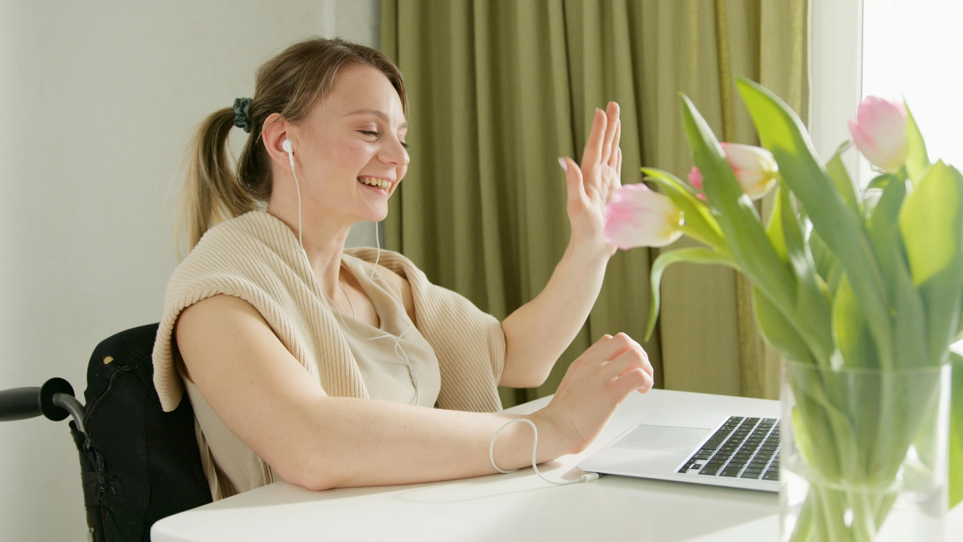 Job candidate attending an accessible virtual interview with video call support and adaptive technology.