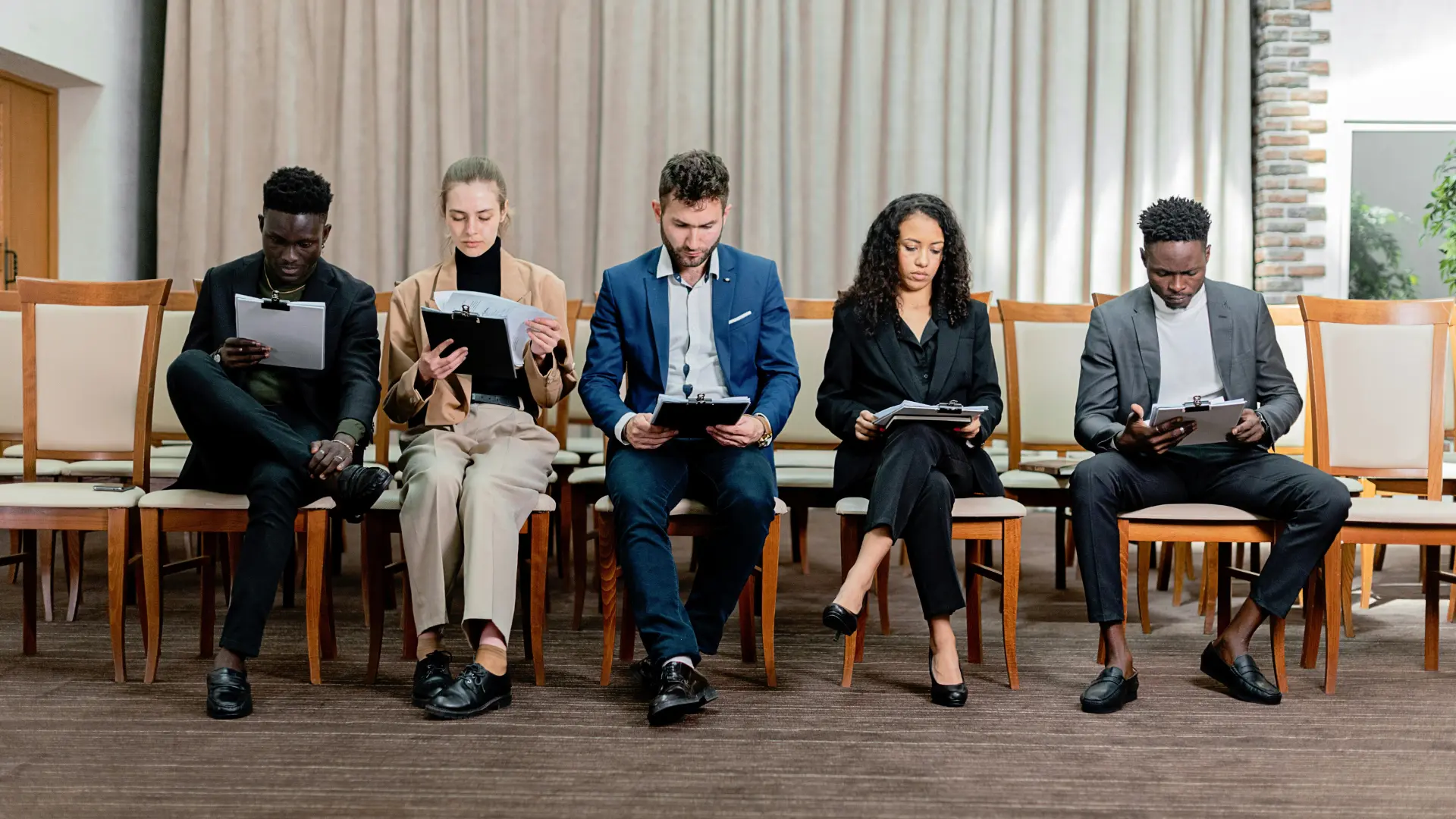 Job candidates reviewing applications during a skills-based hiring process focused on practical abilities over degrees.