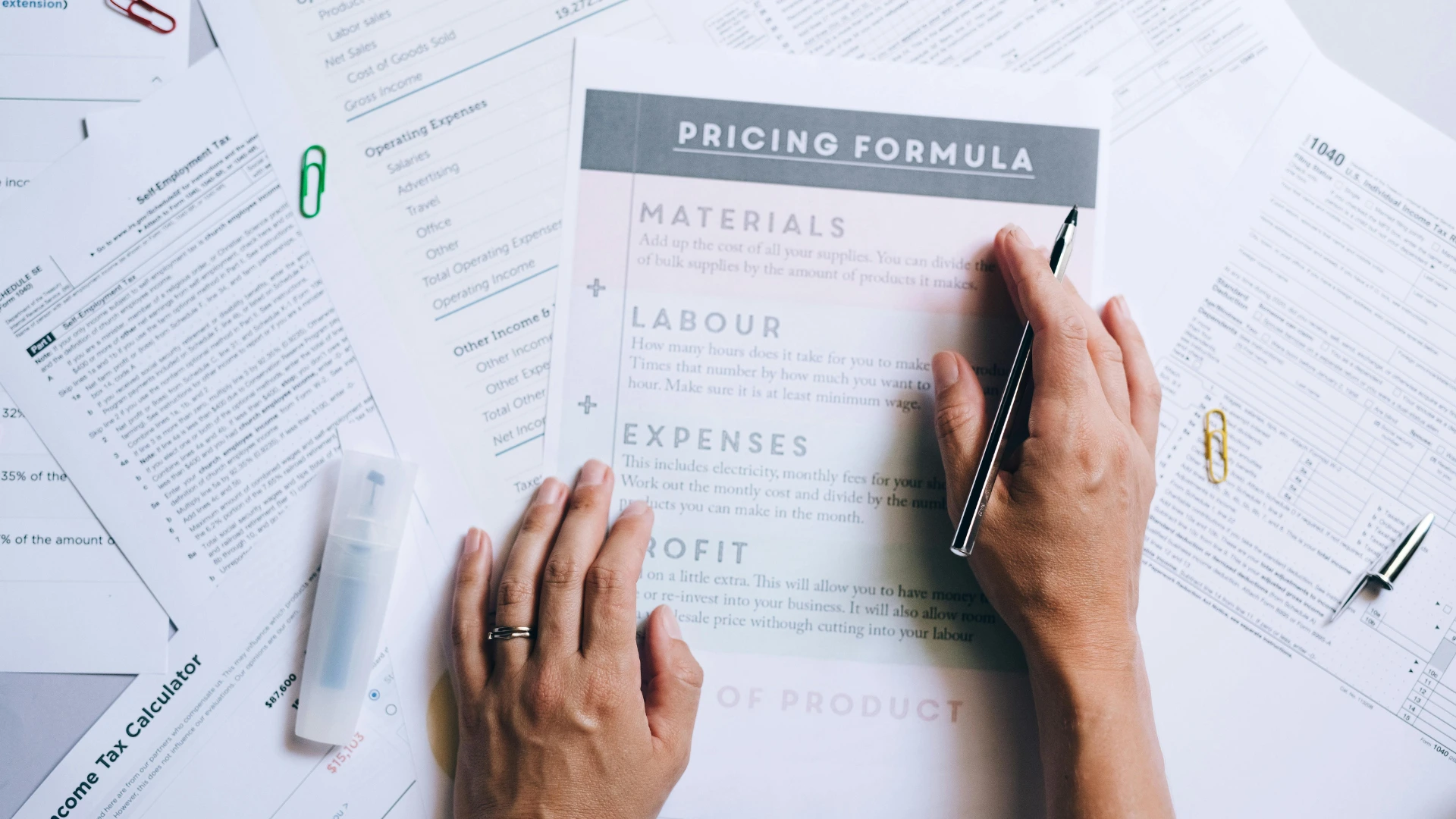 Event organizer reviewing sponsorship pricing formulas and virtual event revenue planning documents.
