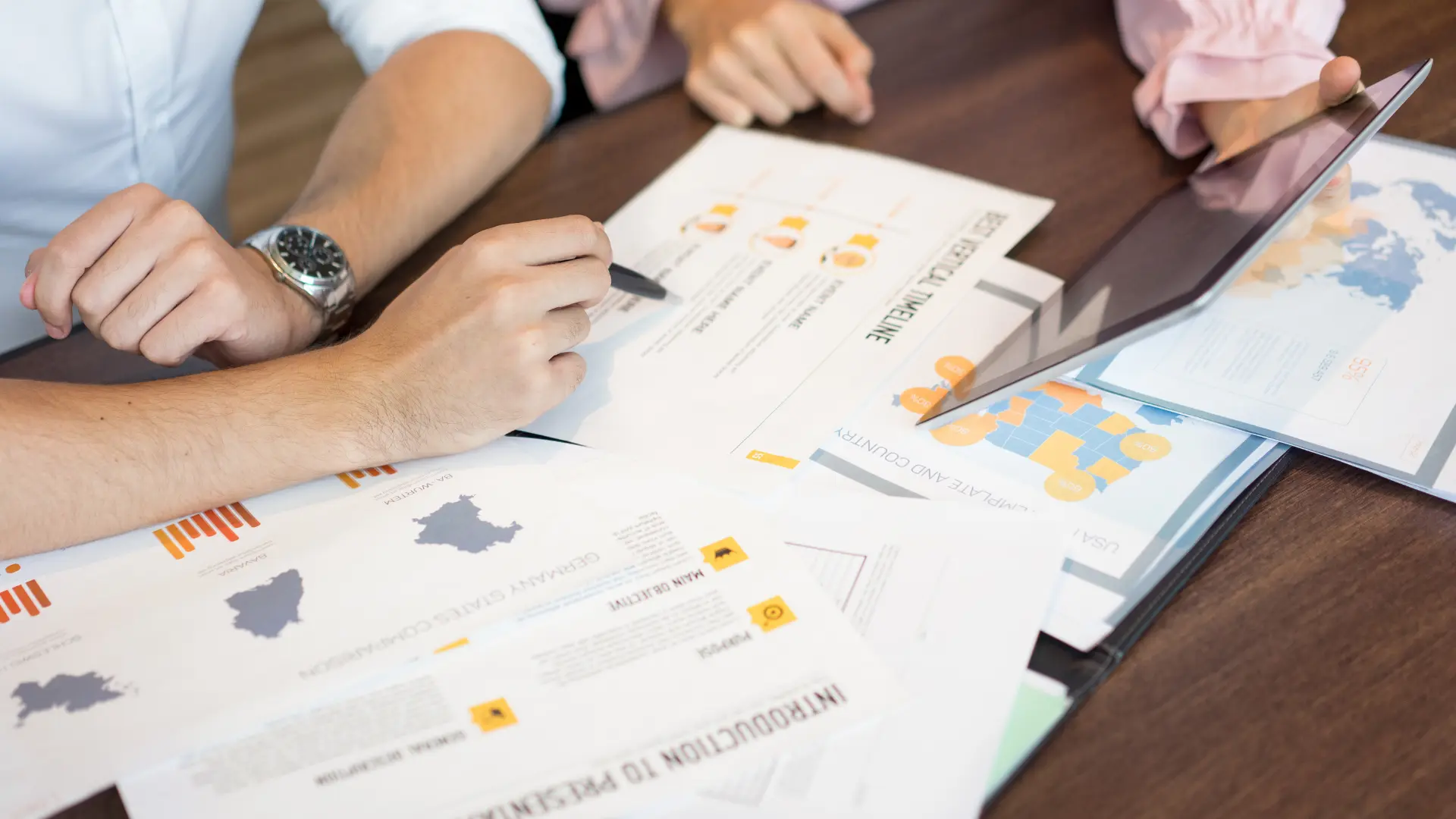 Event planners collaborating over planning documents, budgets, and timelines to organize successful events.
