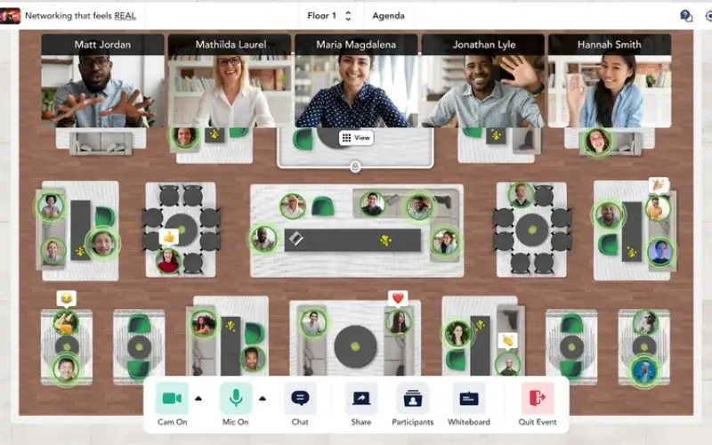 A virtual event floor plan graphic resembling a bird's-eye view of a ballroom with tables, surrounded by live video tiles of networking participants at the top.