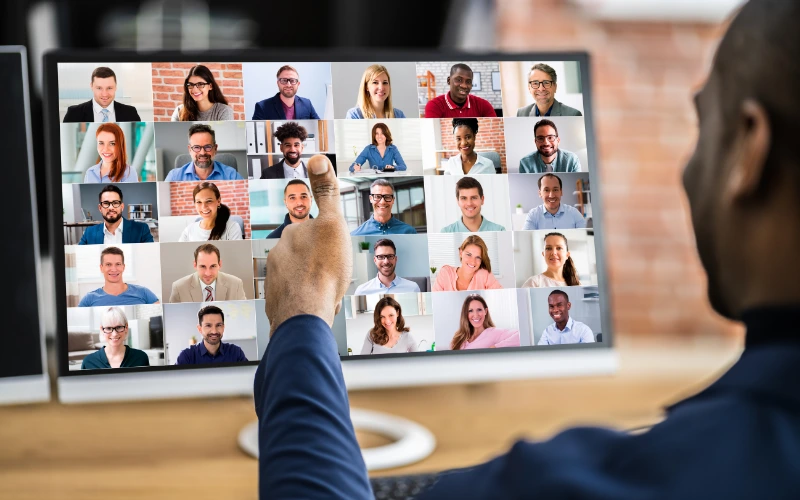 Attendee watching a virtual webinar with multiple speakers displayed on screen.