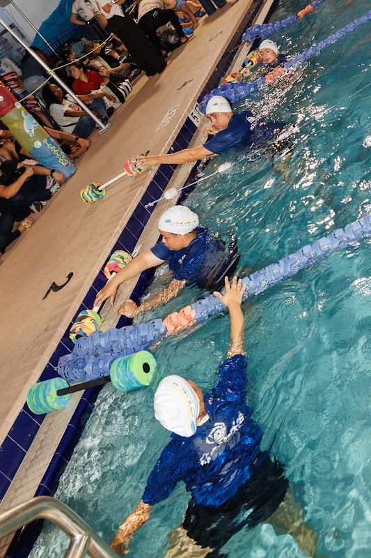 A young swimmer with a coach during the showcase