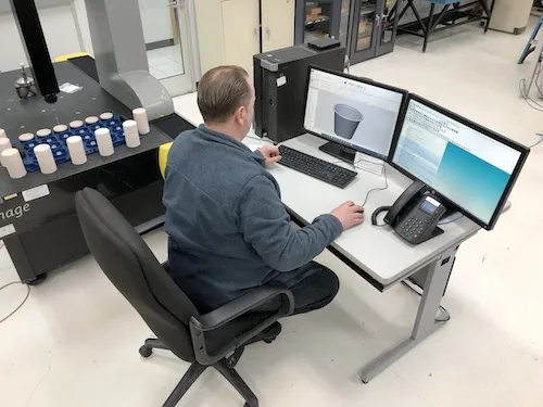 Design engineer working on CAD drawings.