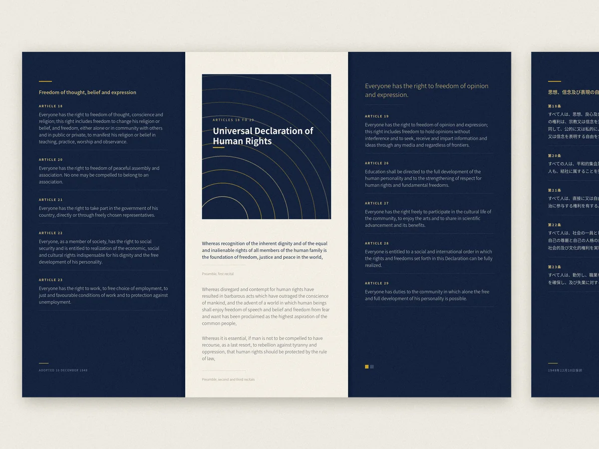 Three printed brochures standing upright, showing brochure and magazine print design