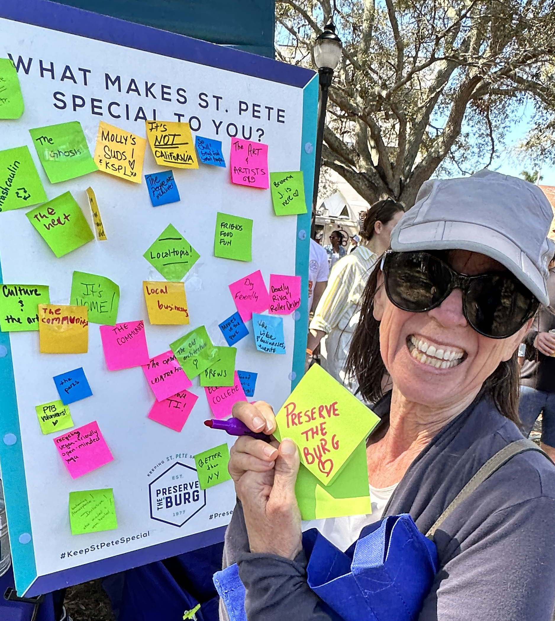 Smiling woman volunteers at a booth