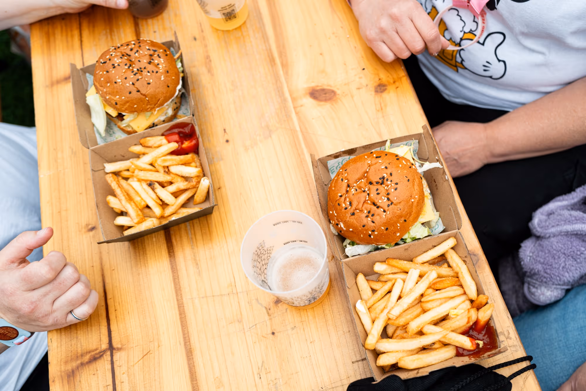 People eating burgers and hot chips from a vendor at the Beerfest