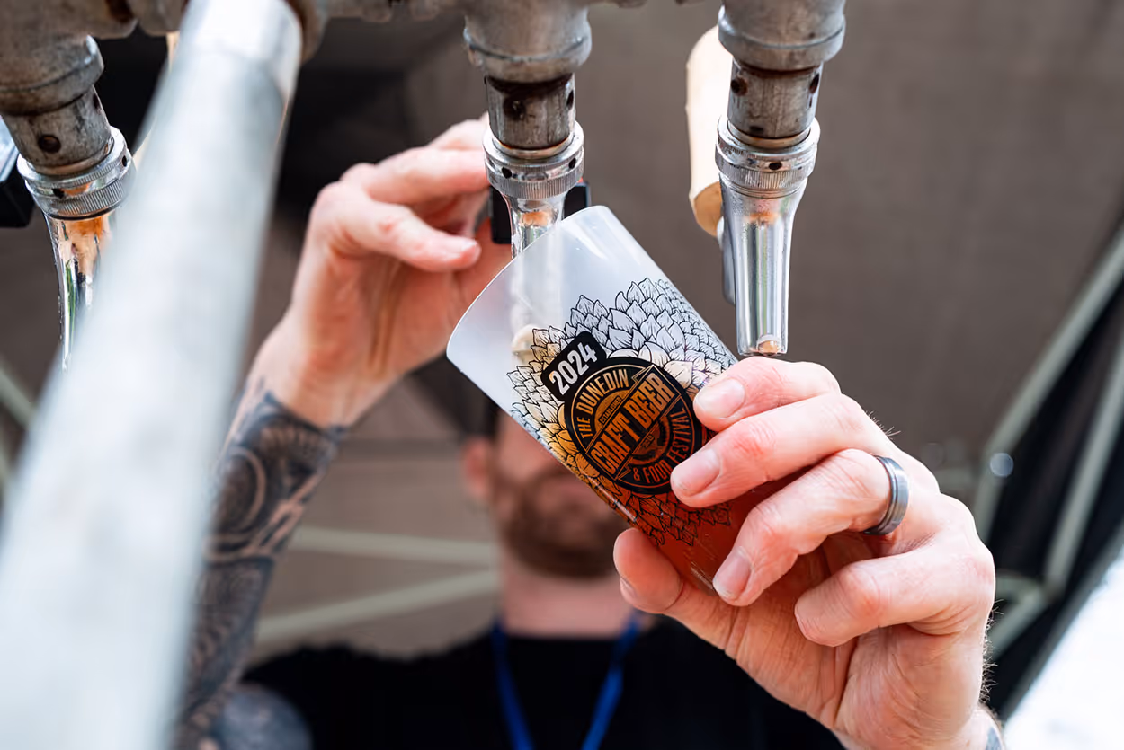 Pouring a beer at the Dunedin Craft Beer & Food Festival in 2024