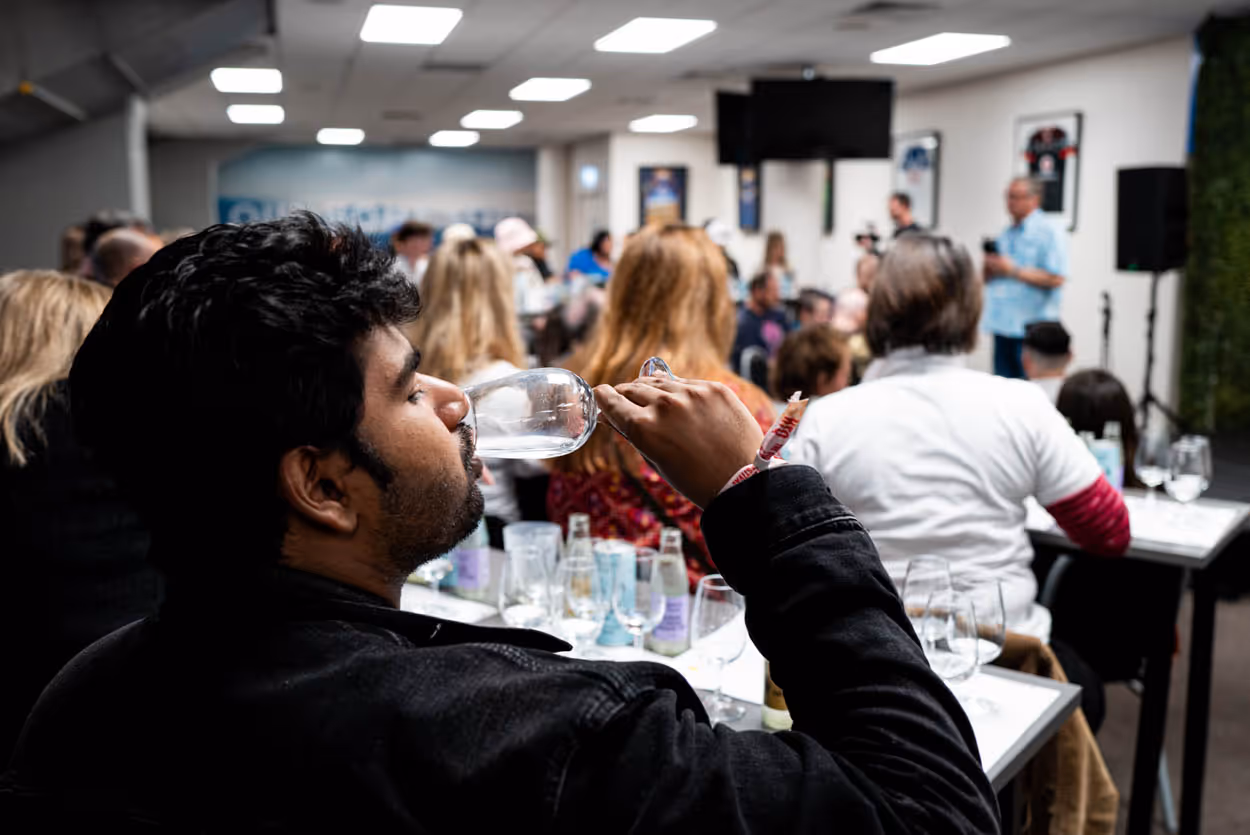Person enjoying a beverage at the 2024 tasting rooms