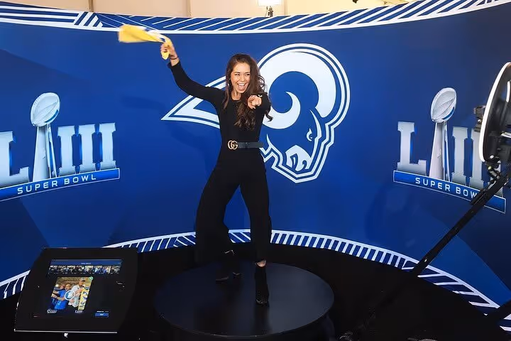 360 Photo Booth in front of an NFL backdrop
