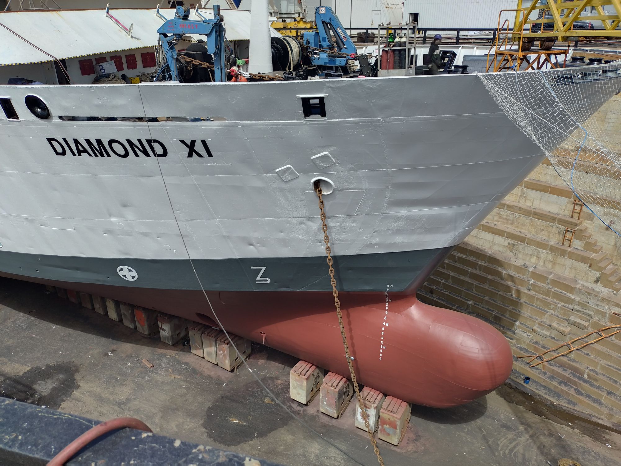 Diamond XI's bow freshly repainted and renamed in dry dock, following conversion from Ocean Diamond.